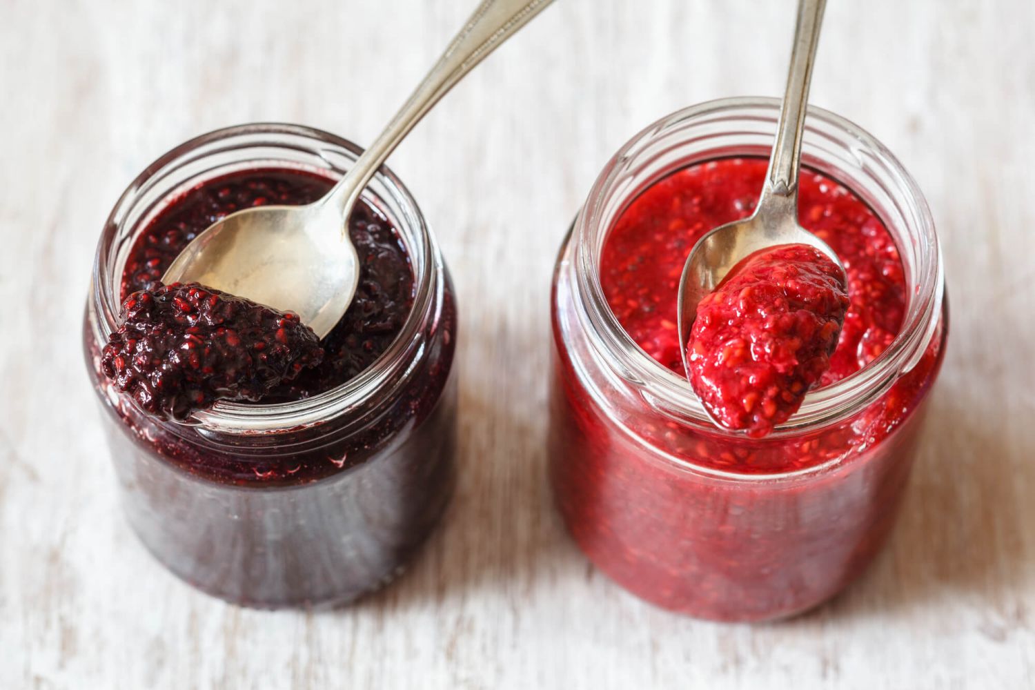Berry Chia Seed Jam Chai seed jam with fresh berries in glass jars.