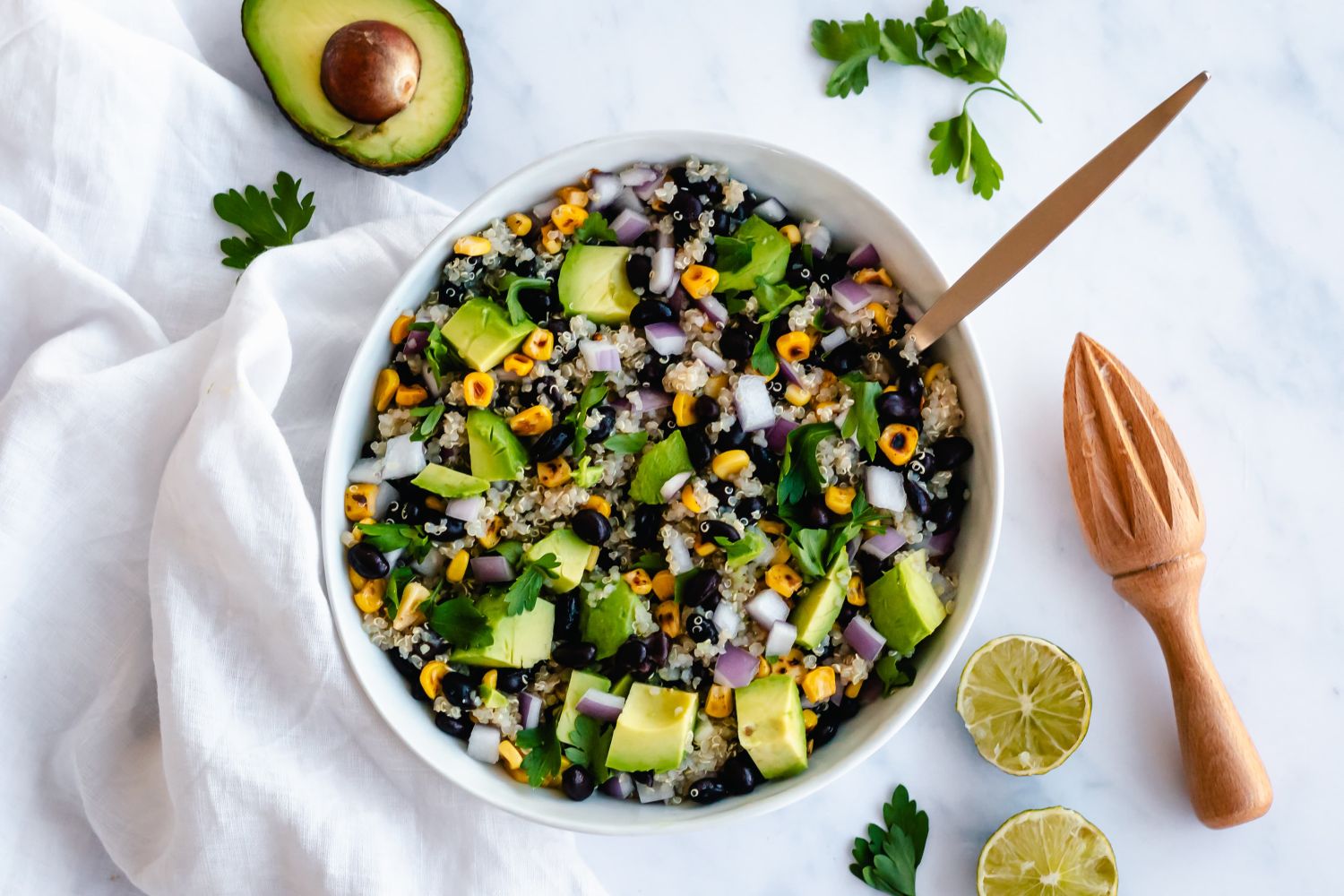 Southwest Quinoa Salad with Black Beans Southwest Quinoa Salad with black beans, corn, and cilantro dressing in a bowl.