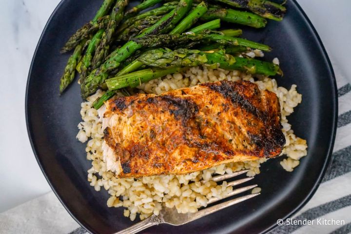 Cajun Salmon Cajun salmon on a bed of quinoa with asparagus.