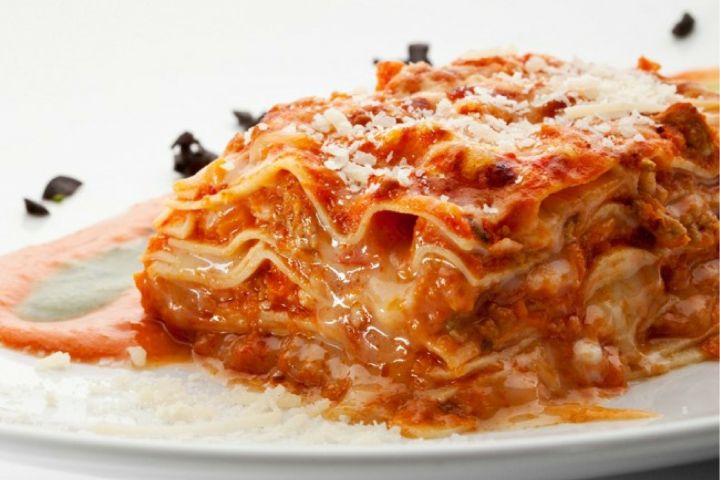 Five Ingredient Chicken Parmesan Lasagna (Slow Cooker or Stove) Chicken Parmesan lasagna with ricotta cheese and cooked chicken on a plate.