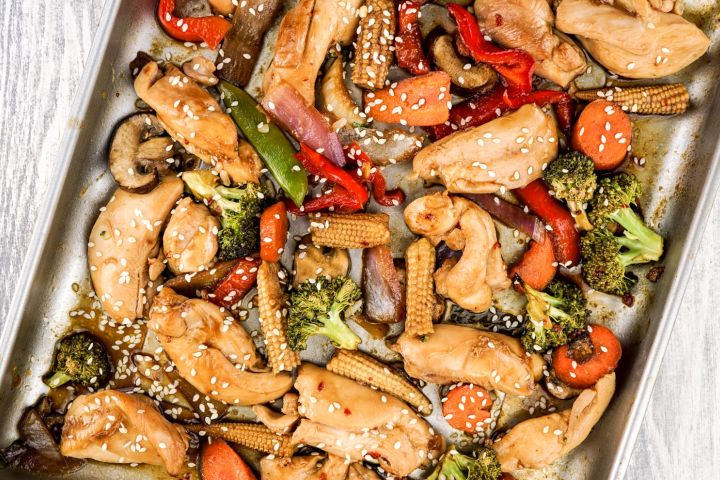 Sheet Pan Asian Chicken Stir Fry Sheet pan Asian chicken stir fry with chicken breast, peppers, broccoli, and other veggies on a sheet pan.
