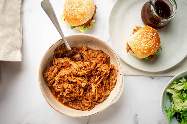 Slow Cooker Spicy Pulled Pork Slow cooker spicy pulled pork with shredded pork tenderloin in spicy barbecue sauce in a bowl.