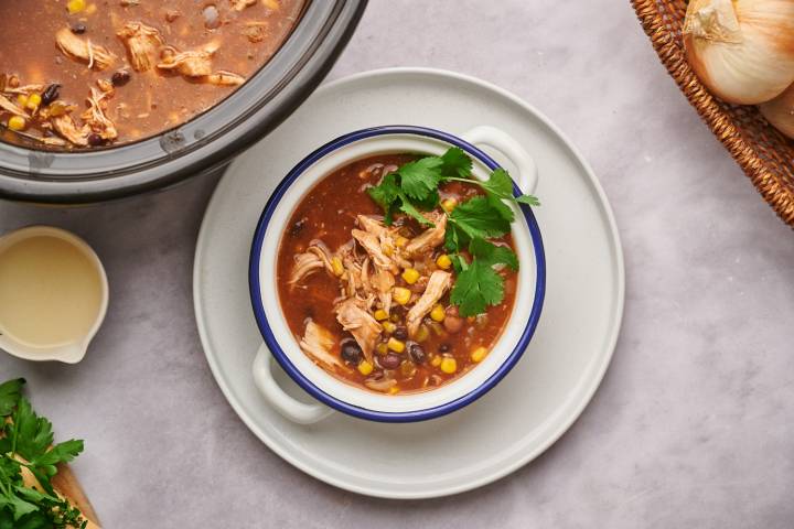 Healthy Taco Soup Healthy taco soup with black beans, pinto beans, shredded chicken, cilantro, and cheese.