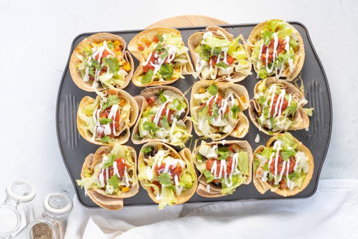 Taco Cups Crispy tortillas filled with black beans, cheese, lettuce, salsa, and sour cream.