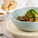 Moo Shu Beef Stir Fry Moo Shu beef stirfry with sliced cabbage and cilantro in a blue bowl.