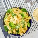 One Pot Creamy Parmesan Broccoli Pasta Broccoli pasta in a bowl with creamy parmesan sauce and Parmesan cheese on the side.