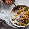 Brussels Sprouts Pasta with Bacon Brussels sprout pasta with bacon and Parmesan cheese in a bowl with a spoon.