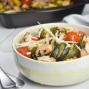 Sheet Pan Italian Chicken and Vegetables Italian chicken and vegetables in a bowl with Parmesan cheese.