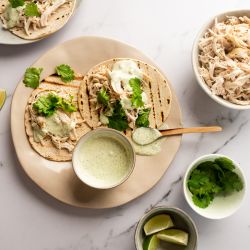 Slow Cooker Jalapeno Chicken Tacos Slow cooker jalapeno chicken tacos with cilantro and Greek yogurt sauce served on corn tortillas.