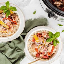 Slow Cooker Italian Red Pepper Chicken Slow cooker red pepper Italian chicken in a bowl with cooked chicken breast, bell peppers, garlic over white rice.