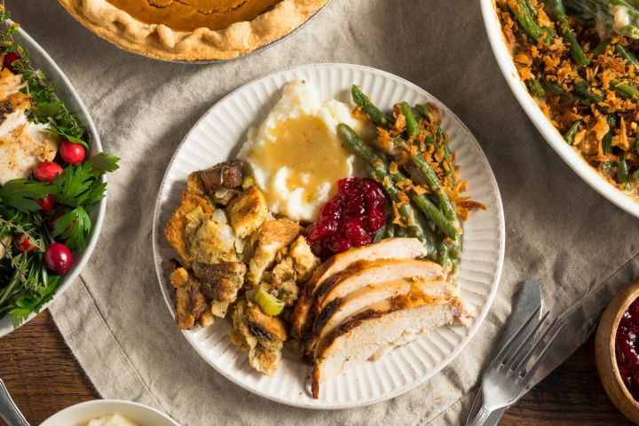 Ultimate Guide to a Healthy Thanksgiving Healthy thanksgiving with roasted turkey, cranberry sauce, mashed potatoes, green beans, and stuffing.
