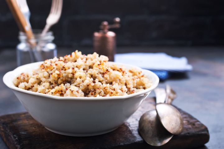 Ultimate Guide to Quinoa: Cooking It, Health Benefits, and Recipes Ultimate guide to quinoa with a picture of cooked quinoa in a bowl.