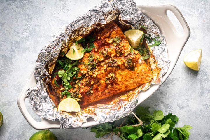 Twenty Five Whole30 Fish Recipes Whole30 Cilantro lime fish recipe with salmon, garlic, cilantro, butter, and limes.