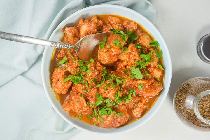 Twelve Slow Cooker Chicken Thighs Recipes Slow cooker chicken tikka masala made with chicken thighs, cauliflower, and a coconut curry sauce.