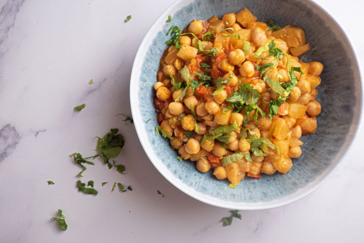 Slow Cooker Sweet and Sour Chickpeas with Pineapple Slow cooker sweet and sour chickpeas with pineapple, red pepper, and cilantro in a bowl.