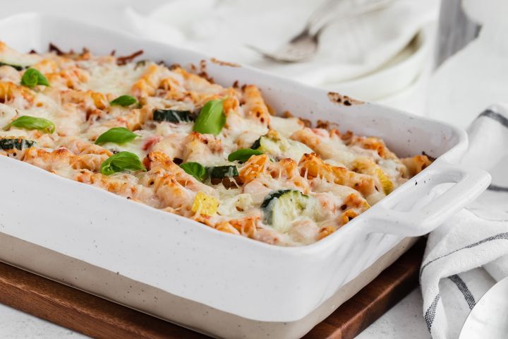 Baked Roasted Vegetable Ziti Roasted Vegetable Baked Ziti with melted cheese in a white casserole dish.
