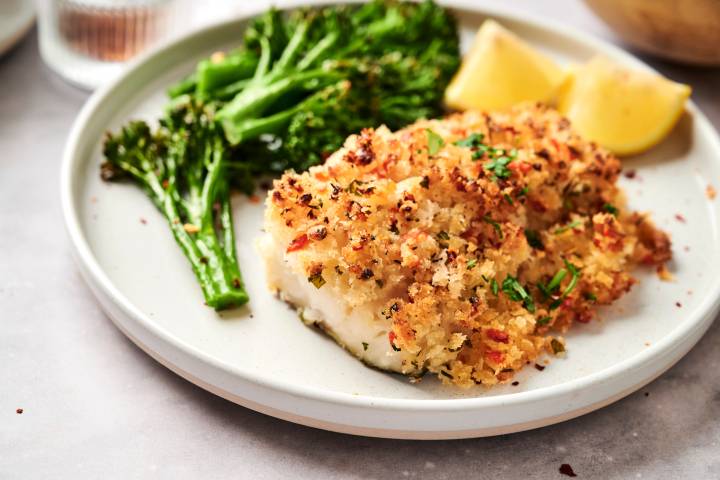 Baked Stuffed Haddock (Seafood Stuffing) Baked haddock with seafood stuffing served with broccoli and lemon wedges.