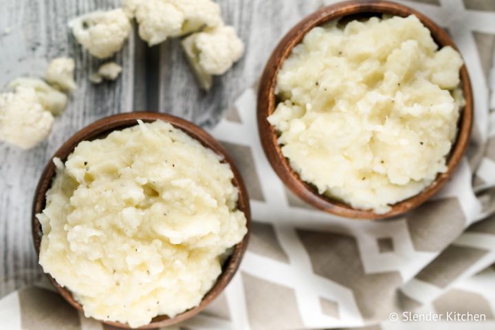 The Best Mashed Cauliflower Mashed cauliflower served in two small wooden bowls.