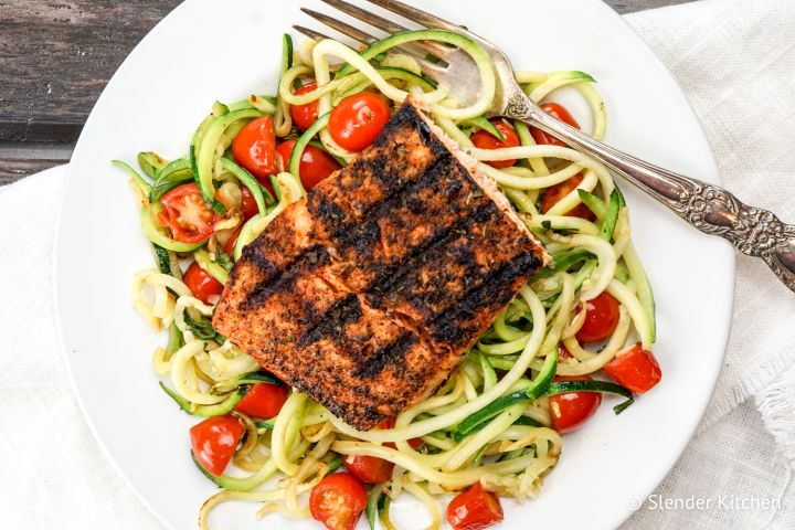 Blackened Salmon with Garlic Zucchini Noodles Blackened Salmon over a bed of zucchini noodles with cherry tomatoes.