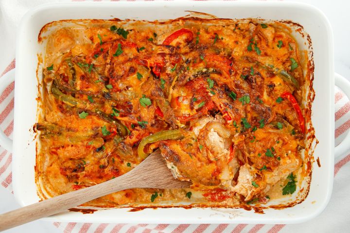 Chicken Fajita Casserole Chicken fajita casserole baked in a dish with peppers, onions, chicken breast, and melted cheese.