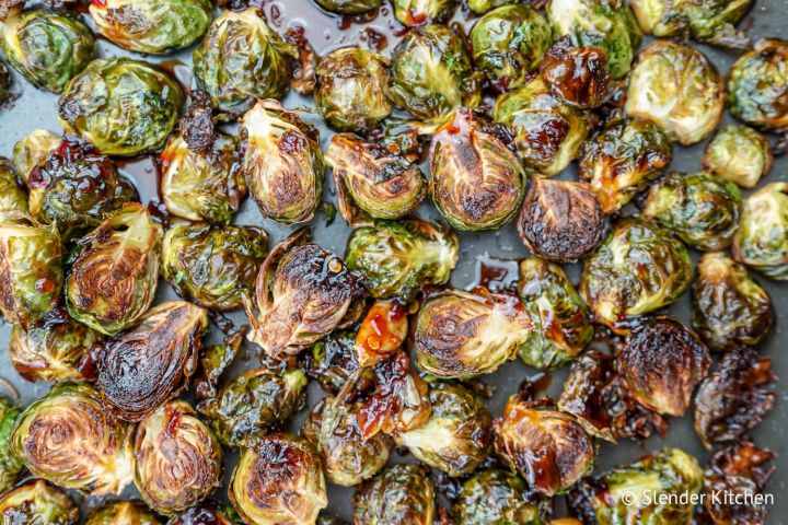 Crispy Asian Brussel Sprouts Crispy Asian Brussel sprouts on a baking sheet with soy sauce and honey glaze.