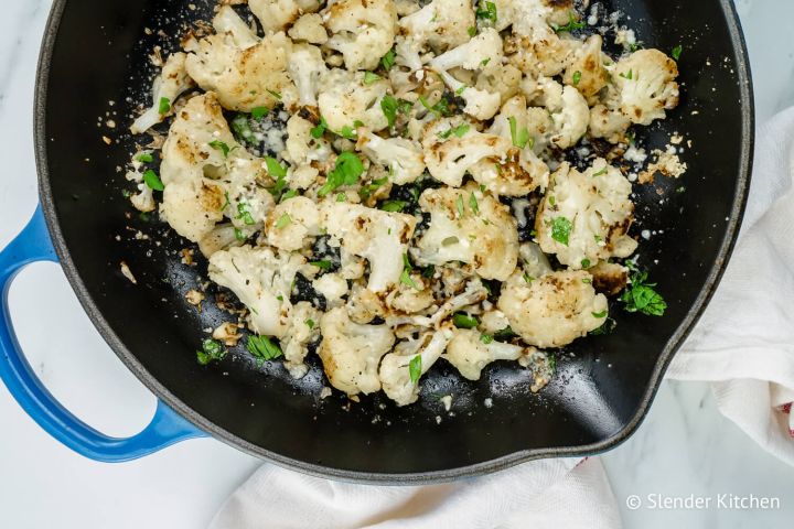 Pan Roasted Cauliflower Garlic Parmesan Roasted Cauliflower in a skillet with fresh parsley.