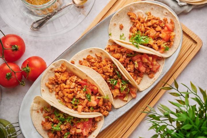 Ground Chicken Tacos Ground chicken tacos with seasoned ground chicken, tomatoes, and lettuce in flour tortillas.