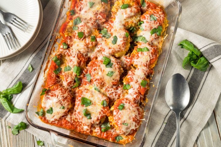 Healthy Eggplant Parmesan Healthy Eggplant Parmesan in a casserole dish with tomato sauce and melted cheese.