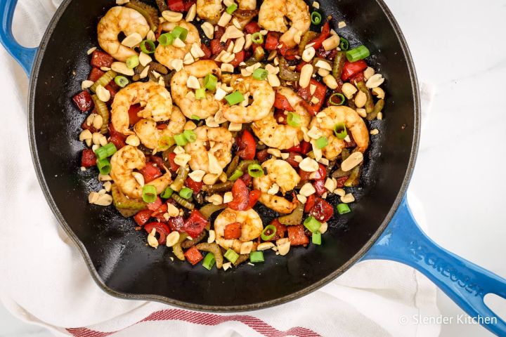 Kung Pao Shrimp Kung Pao Shrimp with peanuts, celery, red peppers, and green onions in a skillet.