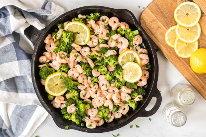 Lemon Pepper Shrimp and Broccoli Lemon pepper shrimp and broccoli in a cast iron skillet with garlic, shrimp, and brocoli florets.