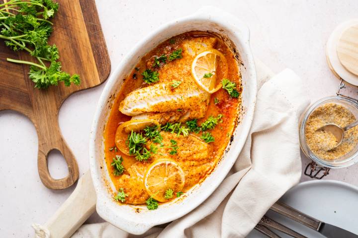 Lemon Pepper Tilapia Lemon pepper tilapia with flaky baked filets topped with lemon pepper seasoning, lemon slices, and parsley.