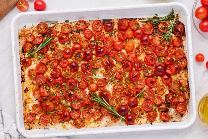 Roasted Grape Tomatoes Roasted grape tomatoes on a baking sheet with olive oil, rosemary, salt, and pepper.