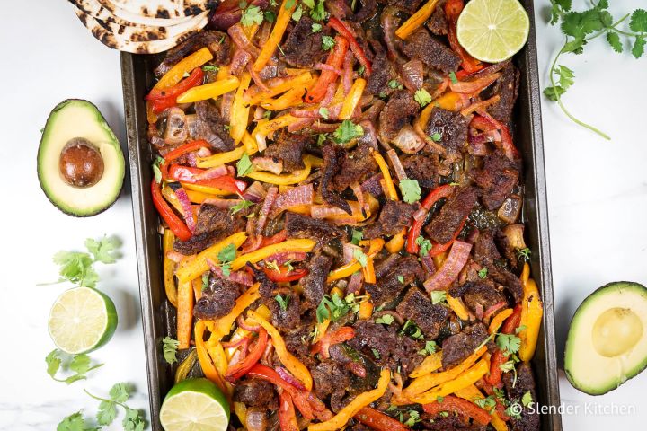 Sheet Pan Steak Fajitas Sheet pan steak fajitas made with homemade fajita seasoning, flank steak, bell peppers, and onions on a sheet pan.