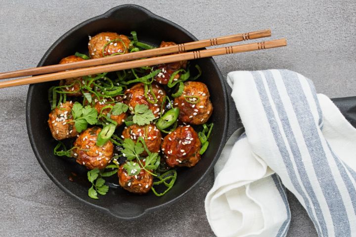 Vegetarian Slow Cooker Asian Meatballs Slow Cooker Asian Meatballs in a skillet with cilantro and green onions on top.