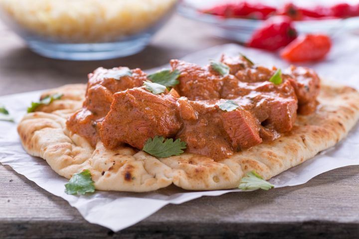 Slow Cooker Butter Chicken | Makhani Slow Cooker Butter Chicken on a plate with white rice and cilantro.