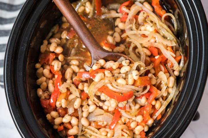 Slow Cooker Tuscan White Beans Slow Cooker Tuscan white beams with sliced red peppers, sliced onions, white beans, and spices in the crockpot.
