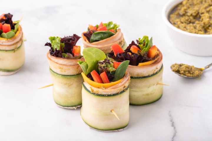 Low Carb Turkey Pesto Roll Up Low carb turkey pesto roll ups with thinly sliced cucumbers, deli turkey, cheese, pesto, and veggies.