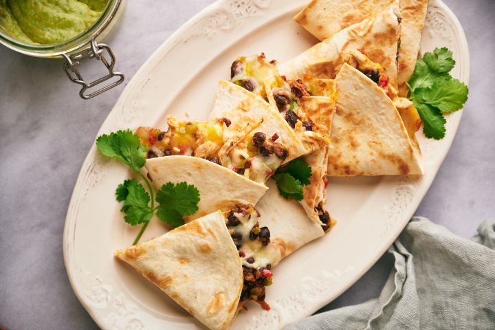 Turkey Quesadillas Turkey quesadillas with shredded turkey, black beans, peppers, and cheese cooked in flour tortillas with cilantro and salsa.