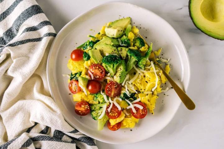17 Macro-Friendly Breakfast Recipes Veggie scramble with broccoli, tomatoes, onions, red pepper, and topped with avocado.