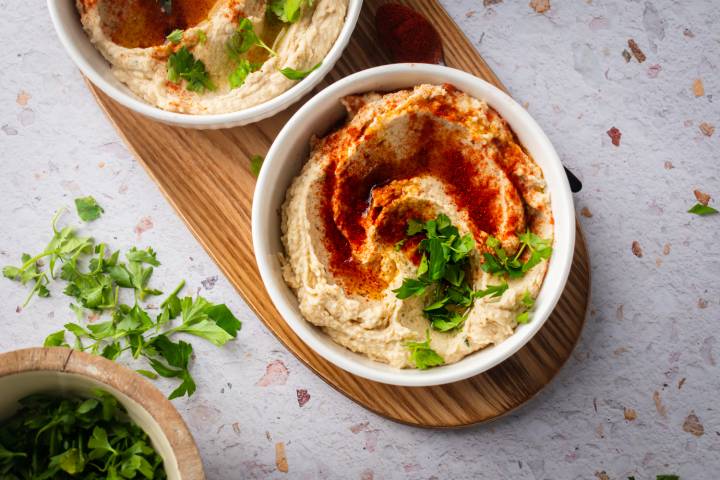 White Bean Hummus White bean hummus served in a bowl with olive oil, paprika, and fresh herbs.
