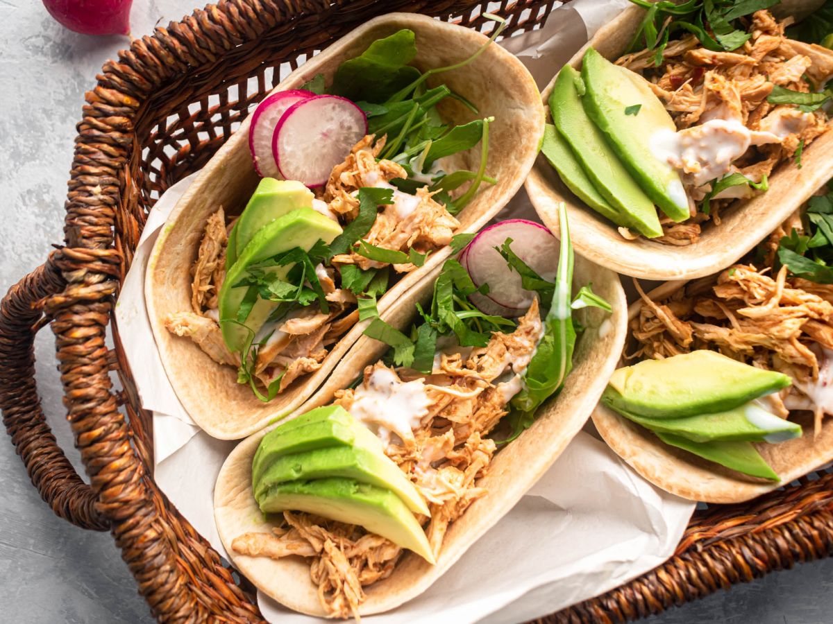 Mexican Chicken Recipes Slow cooker barbacoa chicken shredded and served in corn tortillas with avocado and cilantro.