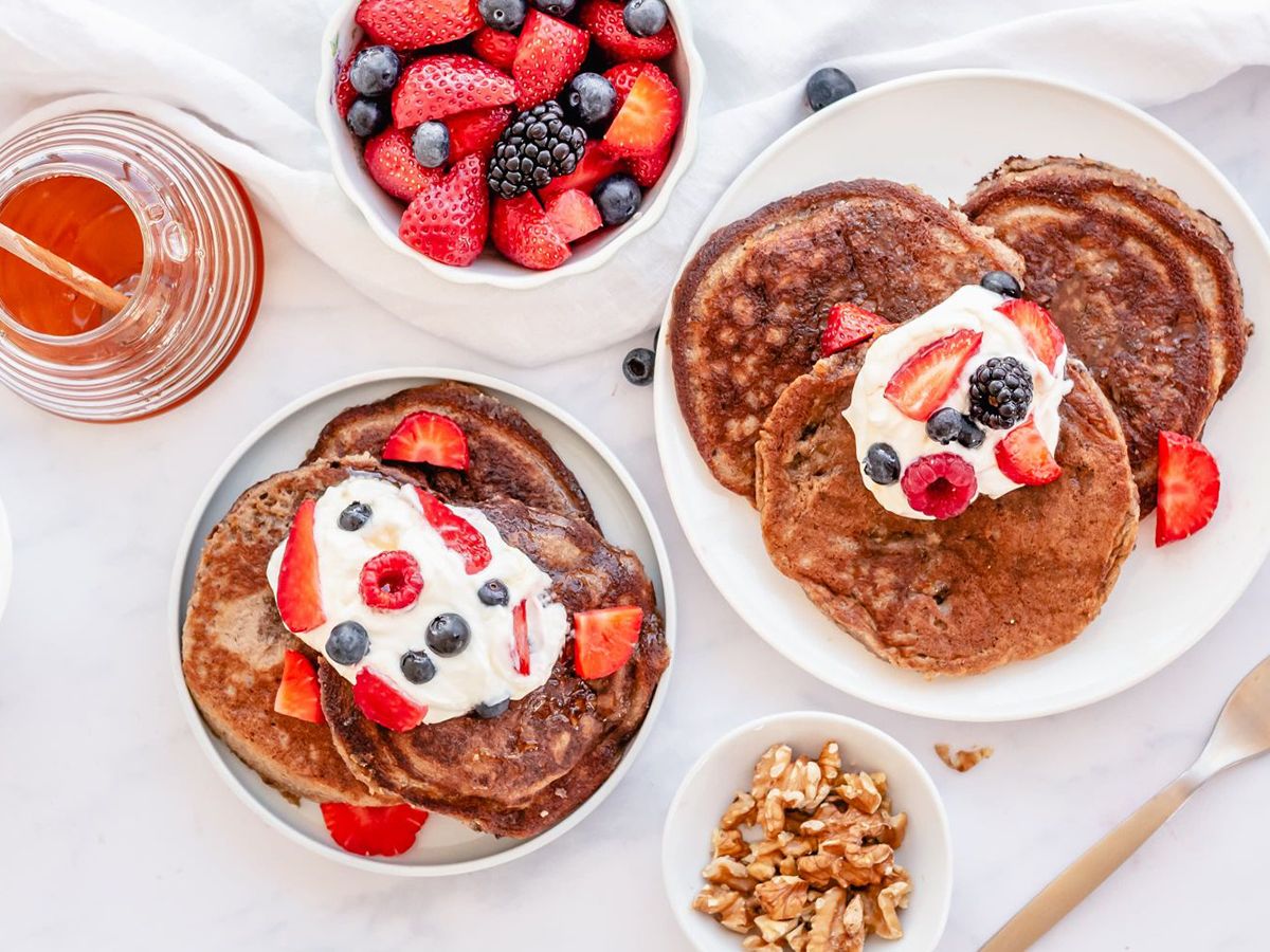 Healthy Dairy Free Recipes Dairy Free Almond FLour Pancakes on a plate with honey and walnuts