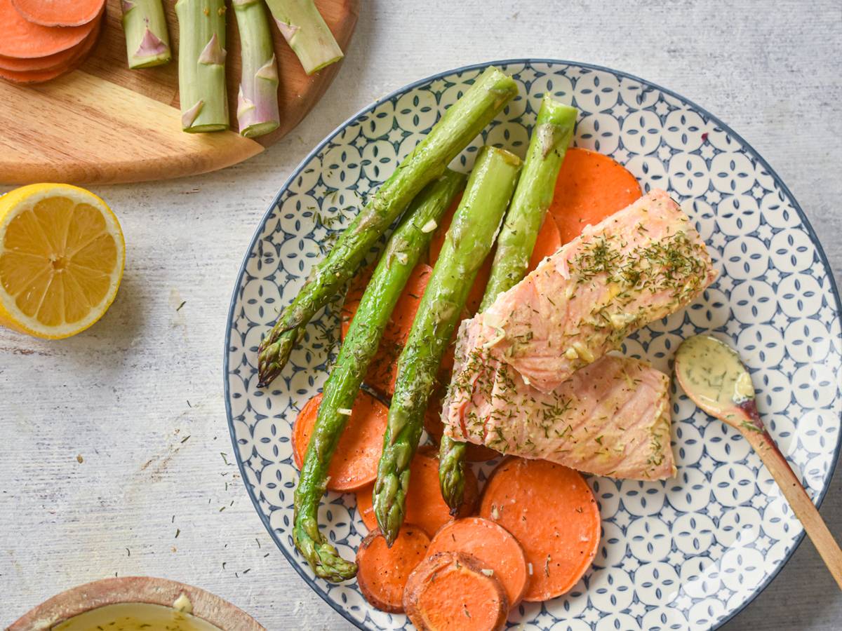 Fish and Seafood Dinners Sheet pan roasted salmon with sweet potatoes and asparagus on a plate with lemon Dijon sauce.