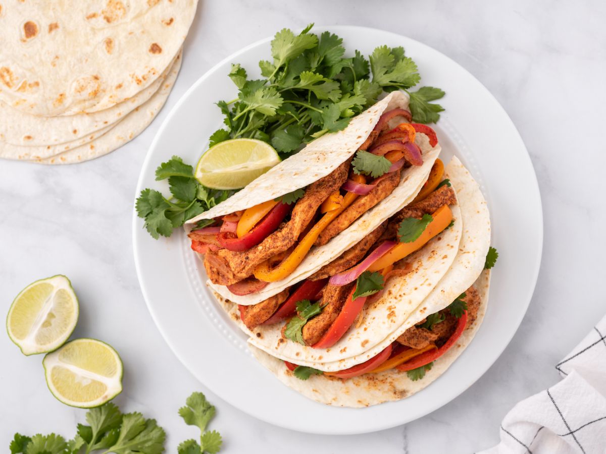 Quick and Easy Dinners Chicken fajitas with peppers, onions, and cilantro in flour tortillas.