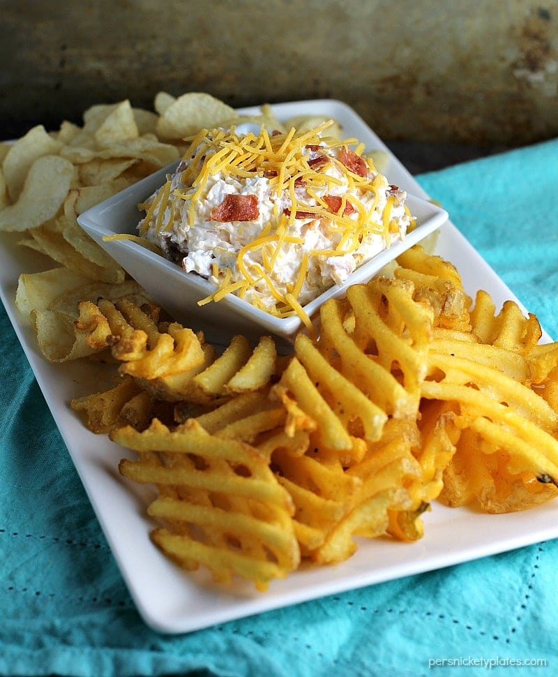 Loaded Baked Potato Dip only has three ingredients and is perfect for game day snacking. If you love loaded baked potatoes, you'll love dipping your chips or potato wedges into this simple dip! | www.persnicketyplates.com