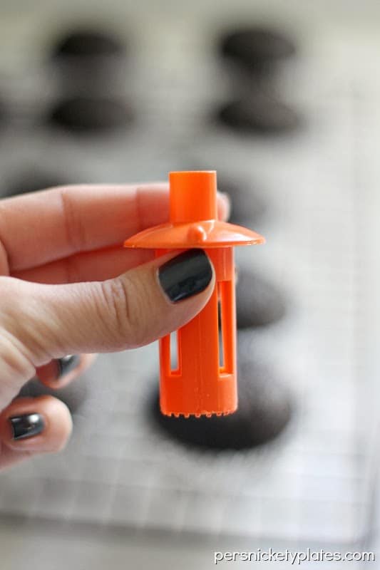 Dark chocolate gender reveal cupcakes filled with pink (or blue) frosting. A fun way to reveal baby's gender! | www.persnicketyplates.com