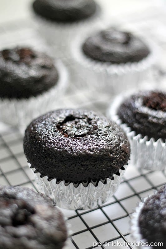 Dark chocolate gender reveal cupcakes filled with pink (or blue) frosting. A fun way to reveal baby's gender! | www.persnicketyplates.com