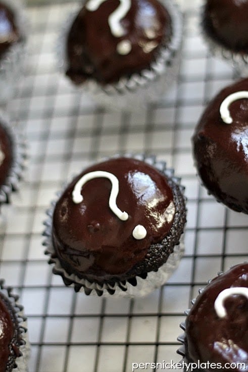 Dark chocolate gender reveal cupcakes filled with pink (or blue) frosting. A fun way to reveal baby's gender! | www.persnicketyplates.com