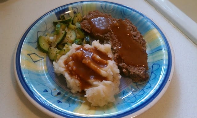 Classic Meatloaf with Brown Gravy for those nights you're feeling nostalgic and want an easy, filling meal. | www.persnicketyplates.com meatloaf, mashed potatoes & gravy, and zucchini on a plate