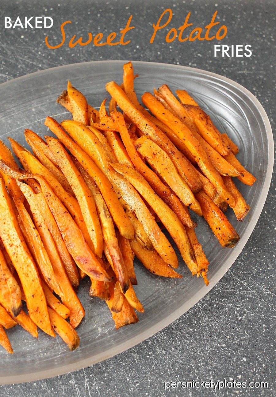plate full of baked sweet potato fries One of my favorite side dishes/snacks - oven baked sweet potato fries with a little kick of chili powder! | www.persnicketyplates.com
